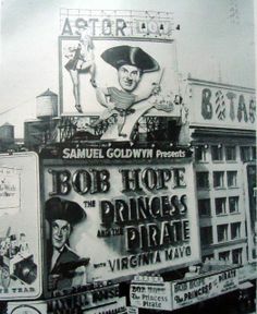 an old black and white photo of billboards