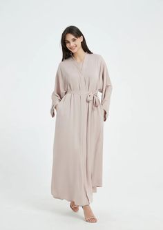 Serena Abaya Set - Light Nude Elegant Workwear Abaya In Maxi Length, Chic Long Abaya For Eid, Elegant Beige Long Thobe, Elegant Long Abaya For Workwear, Elegant Long Beige Thobe, Elegant Belted Abaya, Spring Workwear Abaya, Elegant Solid Color Maxi Length Kaftan, Elegant Spring Kaftan For Loungewear