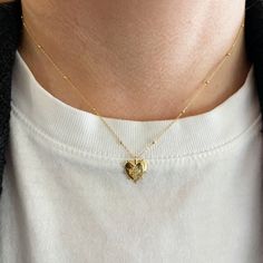 This necklace features a small heart-shaped, beaded edge pendant with a diamond cross center on a beaded satellite chain in 18K yellow gold. Total Diamond Weight: 0.03 ct Chain Length: 15-16" Cross Heart, Beaded Edge, Diamond Cross, Small Heart, Chain Lengths, Chain Length, Gold Pendant, Heart Shapes, 18k Gold