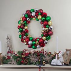 a christmas wreath on top of a mantle