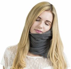 a woman with blonde hair wearing a gray neck gaiter