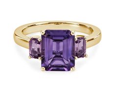 A mesmerizing amethyst sits at the centre of this gorgeous ring, flanked by pink amethysts on either side for a beautiful effect. It is crafted in 14k yellow gold, which promises a warm, timelessly luxurious gleam. Luxury Amethyst Ring Emerald Cut, Luxury Emerald Cut Amethyst Ring, Yellow Gold Amethyst Ring With Emerald Cut, Purple Gemstone Baguette Cut Rings, 14k Gold Emerald-cut Amethyst Ring With Center Stone, Elegant Amethyst Baguette Cut Ring, Purple Gemstone Rings With Baguette Cut, Purple Baguette Cut Gemstone Rings, Emerald Cut Amethyst Ring In 14k Gold