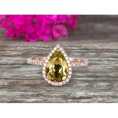 a pear shaped yellow sapphire and diamond ring