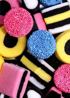 there are many different types of cookies on the table, all decorated in bright colors