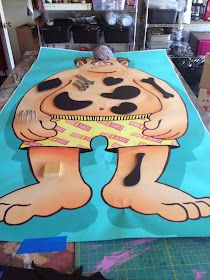 a large paper cut out of a cartoon character on top of a blue table cloth