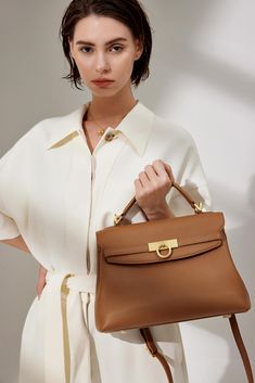 Grace Large Top Handle Bag draws inspiration from vintage door locks and is meticulously crafted with premium Italian full-grain pebbled leather, ensuring both durability and elegance. With its timeless and versatile appearance, this bag is designed with practicality in mind, featuring a well-thought-out interior structure that can comfortably accommodate a 10.2" iPad and all your everyday essentials. Its functional design makes it the perfect choice for those seeking versatility in their daily Light Luxury Satchel Bag For Everyday, Timeless Everyday Luxury Satchel With Double Handle, Timeless Top Handle Shoulder Bag With Leather Lining, Timeless Shoulder Bag With Top Handle And Leather Lining, Timeless Top Handle Bag For Everyday Luxury, Timeless Everyday Luxury Top Handle Bag, Formal Beige Pebbled Leather Shoulder Bag, Timeless Briefcase With Gold-tone Hardware For Daily Use, Luxury Handheld Briefcase For Office