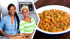 two women standing next to each other in front of a bowl of beans and carrots