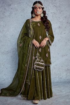 Featuring an olive green kurta in velvet base with embroidery. It is paired with a matching gharara and an organza dupatta. This product will be shipped to you after 1-2 weeks from the date of order placed. All custom made orders are not returnable. Pls contact for Size chart and for other more colors Request You :To provide contact details for courier services. {VARIATION MAY COME DEPENDING UPON AVALIBILITY OF LACES OR GOTTA PATI or TUSSELS} NOTE:  1) Visual Samples on website may differ slightly from actual product due to light & effects during photography (Length & Breadth have 1 n 1.5 inches +/-). 2) Before placing order ,pls confirm product n color availability and  For Wholesale Order MOQ is 5 Pieces of any color/Pattern on +91 7903893945 & +91 8447750028(WhatsApp) Bridal lehanga ,in Luxury Dark Green Dupatta For Festive Occasions, Diwali Velvet Sharara With Mirror Work, Festive Velvet Sharara With Mirror Work, Velvet Anarkali Sharara For Eid, Festive Green Velvet Set, Velvet Anarkali Sharara For Diwali, Green Velvet Sets For Eid, Green Velvet Dupatta Set, Green Velvet Anarkali Traditional Wear