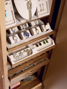 an open drawer with jewelry inside of it