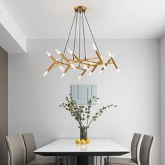 a dining room table with chairs and a chandelier hanging from it's ceiling