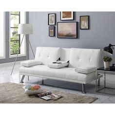 a white couch sitting on top of a rug in a living room