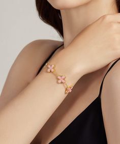 ✧ Material: 24K Yellow Gold Filled | 925 Sterling Silver ✧ Stone: Pink Shell + Diamond Simulant Adorn yourself with the delicate beauty of our 24K Gold Pink Shell Clover Bracelet, where elegance meets natural allure in a stunning piece of jewelry. Meticulously handcrafted, this bracelet is a true symbol of refined craftsmanship and timeless charm. Craftsmanship and Materials: Each bracelet is meticulously crafted with a solid layer of 24K gold over a 925 sterling silver base, ensuring durability Luxury Gold Flower Bracelet, Elegant Pink Gold-plated Bracelets, Gold Plated Chain Bracelet For Her, Exquisite Rose Gold Bracelets For Gifts, Luxury Flower-shaped Bracelets As Gift, Pink Gold Plated Bracelets, Elegant Pink Jubilee Chain Bracelet, Elegant Pink Flower Bracelet, Elegant Pink Flower Shaped Bracelet