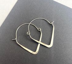 These earrings are made using heavy gauge sterling silver wire shaped into V shapes then hammered flat and polished to a shine. They measure just under 1.5" tall and about 1 1/8" wide. All items are sent inside a sturdy jewelry gift box. Geometric Hoop Earrings, Jewelry Earrings Hoops, Saint Louis, Jewelry Gift Box, Silver Wire, V Shape, Jewelry Gift, Sterling Silver Jewelry, Etsy Earrings