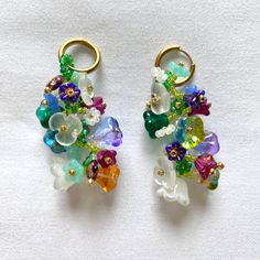 "Indulge in the captivating allure of these beaded floral earrings, a perfect accessory for weddings, graduations, and special events.  Meticulously handcrafted, these exquisite earrings feature high-quality seed beads and Czech glass beads, ensuring both beauty and durability.  With a length of approximately 1.5\", they gracefully dangle and add a touch of sophistication to any outfit. Hoops are made from hypoallergenic stainless steel.  Embrace timeless elegance and celebrate cherished moments Multicolor Artisan Flower Drop Earrings, Multicolor Dangle Flower Earrings, Artistic Multicolor Flower Drop Earrings, Multicolor Flower-shaped Earrings With Colorful Beads, Multicolor Flower-shaped Earrings With Dangling Beads, White Jewelry Box, Whimsical Fashion, White Jewelry, Vintage Crystal