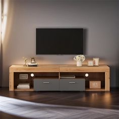 an entertainment center with a flat screen tv mounted on it's wall and drawers