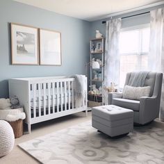 a baby's room with blue walls and white furniture