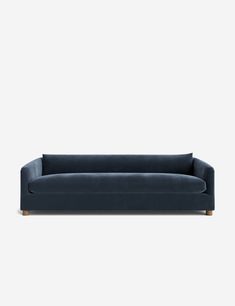 a blue velvet couch with wooden legs and armrests, viewed from the front