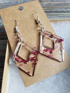 Beautiful geometric diamond earrings with delicate magenta flower. Real dried pink flower in resin earrings, perfectly preserved for eternal beauty. Naturally colorful, and gently lightweight earrings ♥ Be sure to check out the PURPLE EARRINGS section at EarringsbyLCreations for all beautiful purple colored earrings available! https://www.etsy.com/shop/EarringsByLCreations?section_id=28420997 Made with quality materials and always nickel and lead free metals. Naturally colorful jewelry made by h Pink Dangle Earrings With Pressed Flowers, Pink Drop Earrings With Pressed Flowers, Pink Pressed Flower Drop Earrings, Pink Dangle Jewelry With Pressed Flowers, Pink Rectangular Earrings As Gift, Rectangular Pink Earrings For Gifts, Pink Rectangular Earrings For Gift, Pink Rectangular Earrings For Gifts, Elegant Resin Flower Shaped Earrings