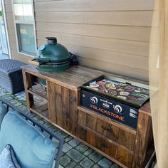 an outdoor bbq table with a grill on it