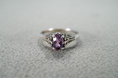 I am offering you this vintage sterling silver, wedding band stacker design ring (stamped). It features a center set prong set oval shaped genuine amethyst stone.  This stone is set in a wonderful raised relief single stone setting. Truly a most spectacular detailed scrolled filigree Victorian -style ring. It is currently a size 9, though I am sure this could easily be sized up or down. It measures app. 3/4 inch, by app. 1/4 inch. It weighs app. 4 grams.   Please review all of my pictures, as th Victorian Style Rings, Vintage Wedding Band, Single Stone, Stone Setting, Amethyst Stone, Silver Wedding, Ring Sterling Silver, Victorian Style, Stone Settings