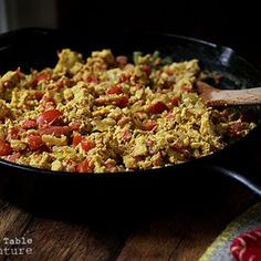 a pan filled with food sitting on top of a wooden table