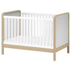 a white crib with no sheets on the bottom and side rails, in front of a white background