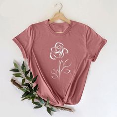 Rose Flowers Tshirt, Cute Flower Shirt, Gift for Rose Lover, Nature Lover Shirt, Botanical Plant Shirts, Ladies Gift Shirts, Rose Mom Shirt, Rose Flowers Tshirt, Ladies Gift Shirts, Cute Flower Shirt, Gifts For Womens, Gift for Rose Lover, Gift for Best Friend, Nature Lover Shirt, Rose Mom Shirt, Botanical Plant Tees, Rose Lover Shirt, Birthday Flower Tee, Womens Botanical Tee, Boho Rose Shirt - Product Details: There are mix of unisex and women's shirts offered. - Reading the Sizing Chart: The sizing chart is already being displayed on listing pictures. They are true to size and we have a mixture of unisex and women's sizes which are already being displayed. If you like fitted look, please purchase one size smaller. Also, they are very quality shirts, they only shrink 3%. - Please review Plant Shirts, Etsy Shirts, Shirt Painting, Soft Core, Olivia Rose, Tshirt Printing, Tshirt Printing Design, Rose Shirts, T Shirt Painting