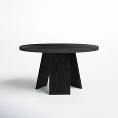 a round table with black wood legs on a white background