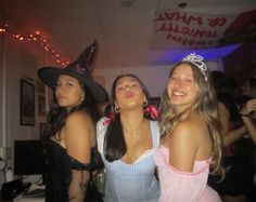 three girls dressed up in costumes at a party