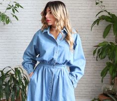 "✿ Vintage 1970's denim shirt dress. Features a point collar, buttoned placket, long sleeves and buttoned barrel cuffs. Relaxed /oversized puffed top with dropped sleeves, cinched waist and long flared skirt. Rear elastic half belt at rear and side waist button tap details. Dual side pockets. We love it paired with campus boots or vintage sandals and paired with a neck scarf. Great find! ✿ Fits like: Medium ✂ Measurements: ( taken laying flat ) Shoulders: 20\" Bust: 21\" Waist: 13\" un-stretched Vintage Long Sleeve Denim Dress With Pockets, Denim Blue Long Sleeve Shirt Dress With Buttons, Long Sleeve Denim Dress With Button Closure For Daywear, Long Sleeve Denim Dress For Daywear, Vintage Button-up Denim Dress For Spring, Vintage Long-sleeve Denim Dress For Spring, Relaxed Fit Denim Dress With Buttons For Daywear, Vintage Long Sleeve Denim Dress For Spring, Spring Vintage Long Sleeve Denim Dress