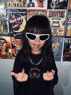 a girl wearing sunglasses making a funny face