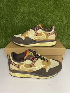 Elevate your shoe collection with these limited edition Nike Air Max 1 x Travis Scott Baroque Brown sneakers. The colorblock design and retro theme make them a versatile choice for both casual wear and activewear. These sneakers feature a lace-up closure and low top shoe shaft style, providing a comfortable fit for walking, running, and jogging. The synthetic upper material is durable and easy to maintain, while the fabric lining material and foam insole material provide added comfort. These sneakers have a standard shoe width and a rubber outsole material for better traction. With a 2021 year of manufacture and a style code of DO9392-200, these sneakers are a must-have for any sneaker enthusiast. Condition: Pre-owned Flaws: Markings Box: Original box All shoes are guaranteed to be 100% au Brown Retro Custom Sneakers For Streetwear, Nike Retro Brown Sneakers, Retro Sneakers With Air Max Cushioning For Sports, Retro Brown Sneakers For Streetwear, Retro Nike Custom Sneakers, Nike Retro Sneakers With Air Max Cushioning, Retro Nike Sneakers With Air Max Cushioning, Retro Sneakers With Air Max Cushioning And Round Toe, Nike Retro Custom Sneakers For Sports