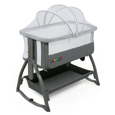 a baby's cradle that is attached to the side of a white and gray stand