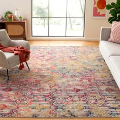 a living room with a couch, chair and rug