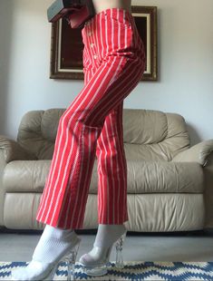 Levi's for Gals Candy striped 1960s low-rise pants in twill cotton with a button fly. Two front pockets. No visible flaws, incredible condition! 26" waist 36" hip 10" rise 26.5" inseam Pinstripe Wide Leg Cotton Bottoms, Red Cotton Bottoms With Button Closure, Fitted Straight Leg Bottoms With Vertical Stripes, Fitted Bottoms With Vertical Stripes And Straight Leg, Red Cotton Bottoms With Buttons, Retro Cotton Pants With Vertical Stripes, Pinstripe Cotton Straight Leg Bottoms, Wide Leg Pinstripe Cotton Pants, Red Straight Leg Bottoms With Button Closure