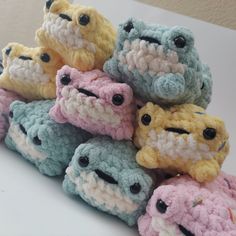 a pile of crocheted stuffed animals sitting next to each other on a table