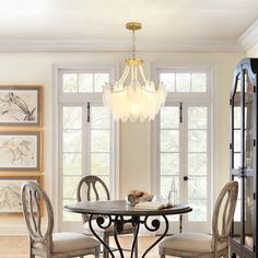 a dining room table with chairs and a chandelier