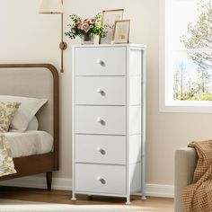 a white chest of drawers in a bedroom