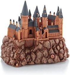 a castle made out of rocks on a white background