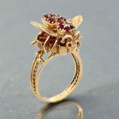 This 14K gold ring features a stunning design of a bee and honeycomb, perfect for vintage ring collectors. The intricate details of the honeycomb and the sparkling diamonds and rubies make this ring a valuable addition to any jewelry collection. Adorn yourself with this timeless piece and showcase your appreciation for vintage charm. Jewelry Style : Ring Metal Type : 14K Gold  Diamonds : Approximately .07 ctw, SI1 Clarity, H Color Ruby : Approximately  .35 ctw Total Weight : Approximately 8 grams  Ring Size : 8 : Can be sized by your local jeweler estate piece, sold as is, all weights are estimates Honeycomb Ring, Gold Bee, Zodiac Pendant, Jewelry Style, 18k Yellow Gold Ring, Ring Metal, Monogram Gifts, 14k Gold Ring, Vintage Engagement