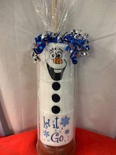 a frosted tube with a snowman on it that says, let it go