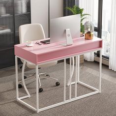 a pink desk with a laptop on it