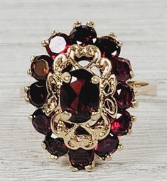 "L-2064  Vintage 1960's Garnet 14K Yellow Gold Ring 7.5 Cluster Retro Luxury Design  AMAZING VINTAGE 1960's NATURAL GARNET CLUSTER COCKTAIL SOLID 14K GOLD RING. WEAR ALONE ON WITH YOUR STACK. WONDERFUL COLOR & HIGHEST QUALITY. WONDERFUL HIGHEST QUALITY. JUST PART OF MY MOST RECENT ESTATE FINDS! FOLLOW ME TO SEE THEM ALL!    Brand: Unbranded Metal: 14K Yellow Gold Metal Purity: 14K Material:  Ring Size: 5.5 Other Dimensions: 3/4\" Form: Ring Luxury Age: Vintage Weight (Grams): 5.4 IT IS IN EXCELL Vintage Gold Cluster Ring With Gemstones, Garnet Cluster Ring, Mid-century Yellow Gold Formal Jewelry, Vintage 14k Gold Cluster Ring Hallmarked, Vintage Hallmarked Ruby Ring For Formal Occasions, Vintage Yellow Gold Cluster Ring, Vintage Yellow Gold Ruby Ring, Vintage Cluster Rings Hallmarked, Vintage 14k Gold Cluster Jewelry