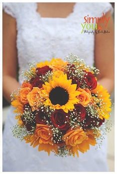 a bridal bouquet with sunflowers, roses and baby's breath