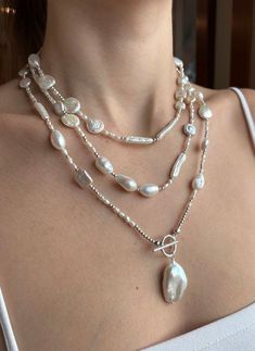 So many shapes and sizes of beautiful white freshwater pearls! Truly unique and so many wearing options. This necklace will work well with everything and will be that perfect go to necklace to wear casual or dressy!  Shown triple wrapped, can also be worn doubled or single, and is perfectly finished with a monstrous baroque focal pearl with gorgeous luster.  All beads are strung on coated stainless wire and the findings are all sterling.  Beautiful statement piece! Necklace measures 58".  Thanks for stopping by! Pearl And Amethyst Necklace, White Lariat Pearl Necklace, White Baroque Pearl Long Necklace, White Baroque Pearl Lariat Necklace, White Lariat Pearl Necklace With Pearl Drop, White Pearl Drop Lariat Necklace, Handmade Silver Lariat Pearl Necklace, White Pearl Lariat Necklace With Pearl Drop, Silver Pearl Lariat Long Necklace