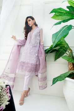 SKU: 802 Price for Shirt, lining and trouser. Pure embroidered net fabric with thread embroidery. Accentuated with laces and organza trimmings. Real crystals and pearl hand embroidery gives an elegant look to this outfit. A three color dupatta with gotta work can be added to this outfit. Shirt length 36. Model is wearing XS. Party Wear Lawn Suit With Dupatta In Organza, Party Wear Lawn Suit With Sheer Dupatta, Party Wear Semi-stitched Organza Lawn Suit, Organza Lawn Suit With Sheer Dupatta For Party, Embroidered Organza Lawn Suit For Party, Unstitched Net Sharara For Eid, Organza Salwar Kameez With Chikankari For Party, Organza Salwar Kameez With Chikankari Embroidery For Party, Elegant Embroidered Net Anarkali Set