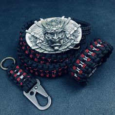 a pair of scissors sitting on top of a black and red paracorine bracelet