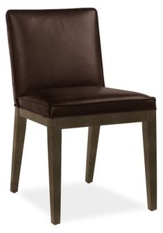 a brown leather dining chair with wooden legs