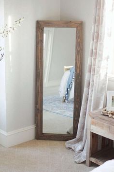 a large mirror sitting in the corner of a room