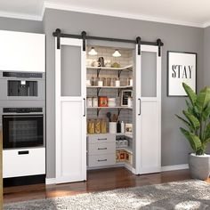 an open pantry with two black handles on the door and one white handle on the door